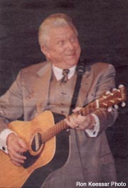 old photo of tommy hunter paying guitar