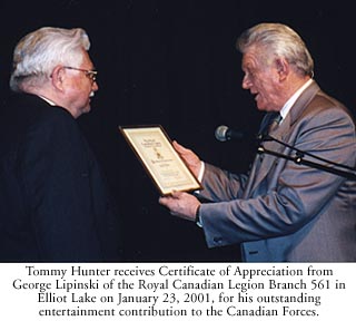 Tommy Hunter recieving and award from the canadian legion.